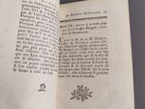 an open book with a black and white image of flowers on it