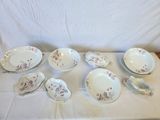 a lot of plates and spoons sitting on a table