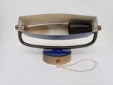 a black and white purse with a blue handle on a white table