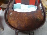 a wooden chair that has a bunch of balls in it