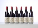 six bottles of red wine lined up in a row