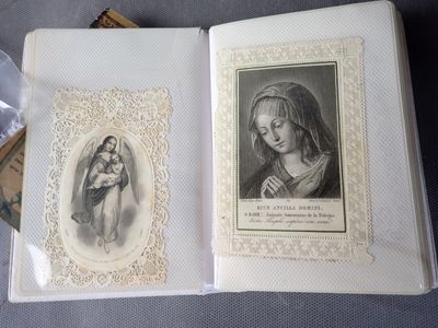 an open book with a picture of a woman holding a child