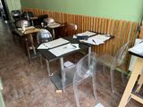 many tables and chairs in a room with a lot of papers