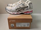 asics gel - kayano running shoe in a box on a table