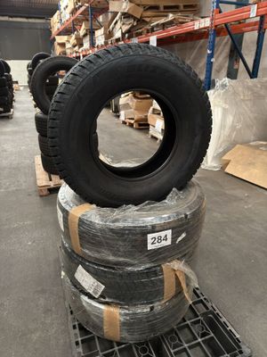 tires are stacked on pallets in a warehouse with pallets of pallets