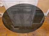 a round table with a mirror on it in the middle of a room