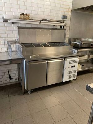une grande cuisine équipée d'appareils électroménagers en acier inoxydable