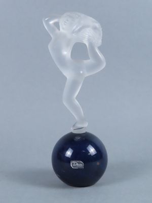 the figurine is sitting on top of a ball with smoke coming out of it