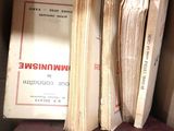 many old books on a shelf in a box