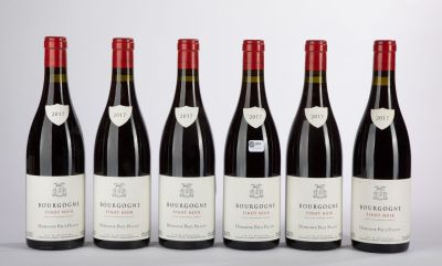 six bottles of red wine are lined up in a row