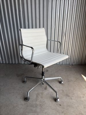 an image of a white office chair sitting in front of a corrugated wall