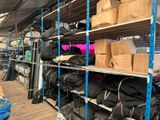 many boxes and bags on the shelves in the warehouse