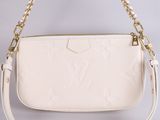 a white louis vu vu bag with gold chain strap