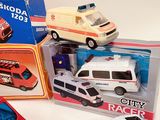 three toy cars that are in a box on the table