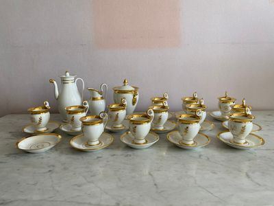 many cups and saucers sitting on a marble table
