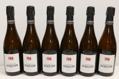 six bottles of wine are lined up in a row on a table