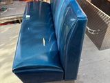a blue couch that is sitting on a wooden floor