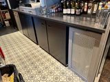 a bar with a bunch of bottles of wine on top of it