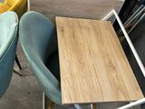 several chairs and a table in a room with a book shelf