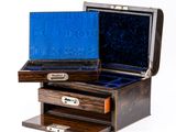 a small wooden box with two drawers on top of it