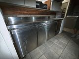 a kitchen with a stainless steel refrigerator and dishwasher
