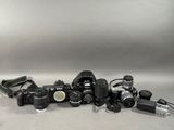 a lot of cameras that are sitting on a table