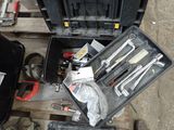 many tools in a tool box on the floor