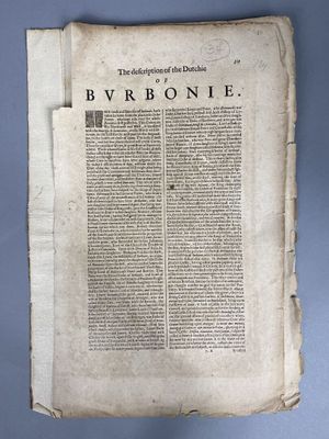 an old book with writing on it sitting on top of a table