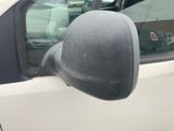a side view mirror of a white truck with a dog sitting in the passenger seat