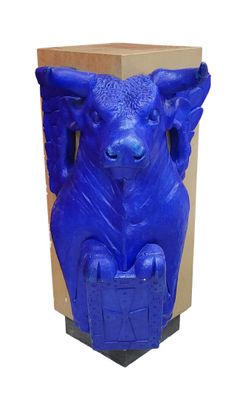 a blue statue of an elephant sitting on a box