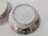 a small bowl and a small bowl sitting on a table