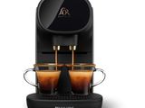 a black coffee machine with two cups of coffee in front of it