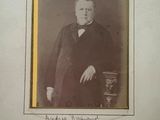 an old photo of a man in a suit and tie posing for a picture