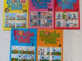 quatre livres pour enfants sont alignés sur une surface blanche