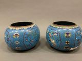 pair of blue vases with birds and flowers painted on them