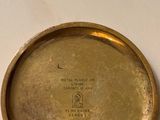 a gold plate with a clock on top of it