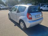 a small silver car parked in a parking lot