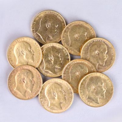 a pile of gold coins on a white surface