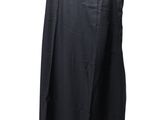a black dress hanging on a hanger on a white background