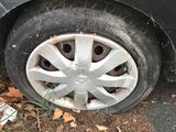 the tire of a car with a flat tire on the side of the road