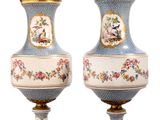 pair of blue and white vases with birds and flowers on them