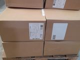 boxes stacked on a pallet in a warehouse with a yellow line