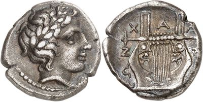 a silver coin with a head of a woman on it