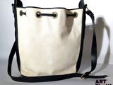 an image of a white and black bag with a black handle