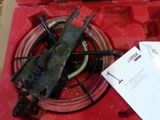 a red box with tools inside of it on a table