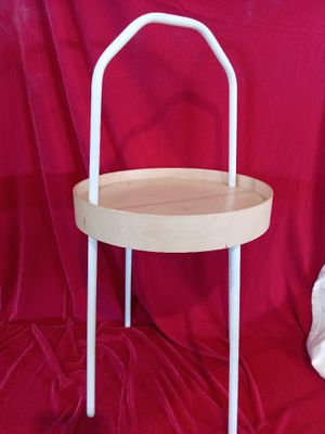 a small wooden table with a chair on top of it