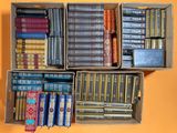 many books in a box on a yellow surface