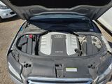 the engine of a car with its hood open in a parking lot