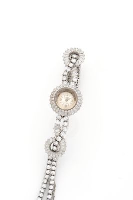 a close up of a wrist watch with diamonds on a white background