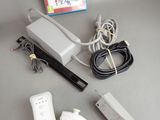 a nintendo wii game system sitting on a table next to a wii controller